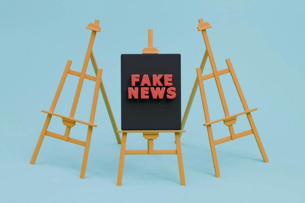 a fake news sign sitting on top of a easel